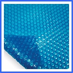 Close-up of a sheet of turquoise bubble wrap, with focus on the texture and details of the popped and unpopped bubbles. | AES - Pool Heating & Energy Efficient Products